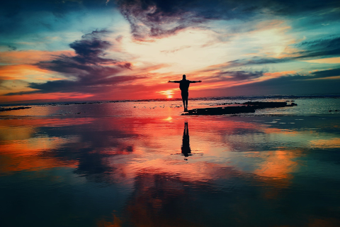 Image of person on a beach at sunset